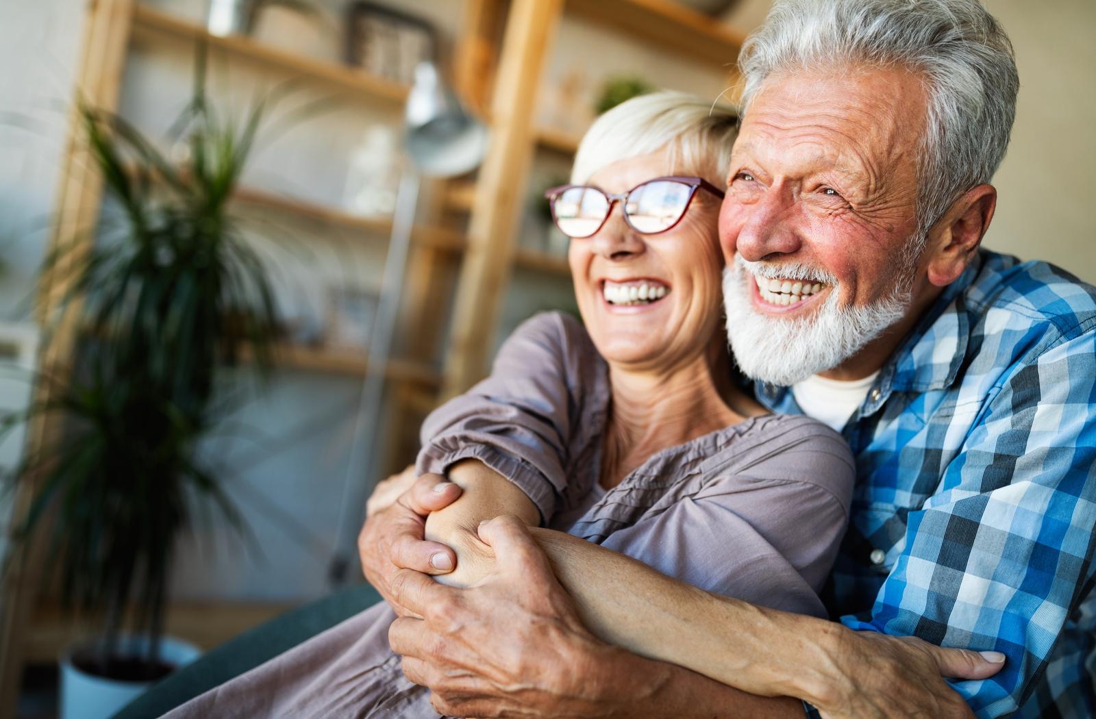 Two seniors holding each other in pure happiness